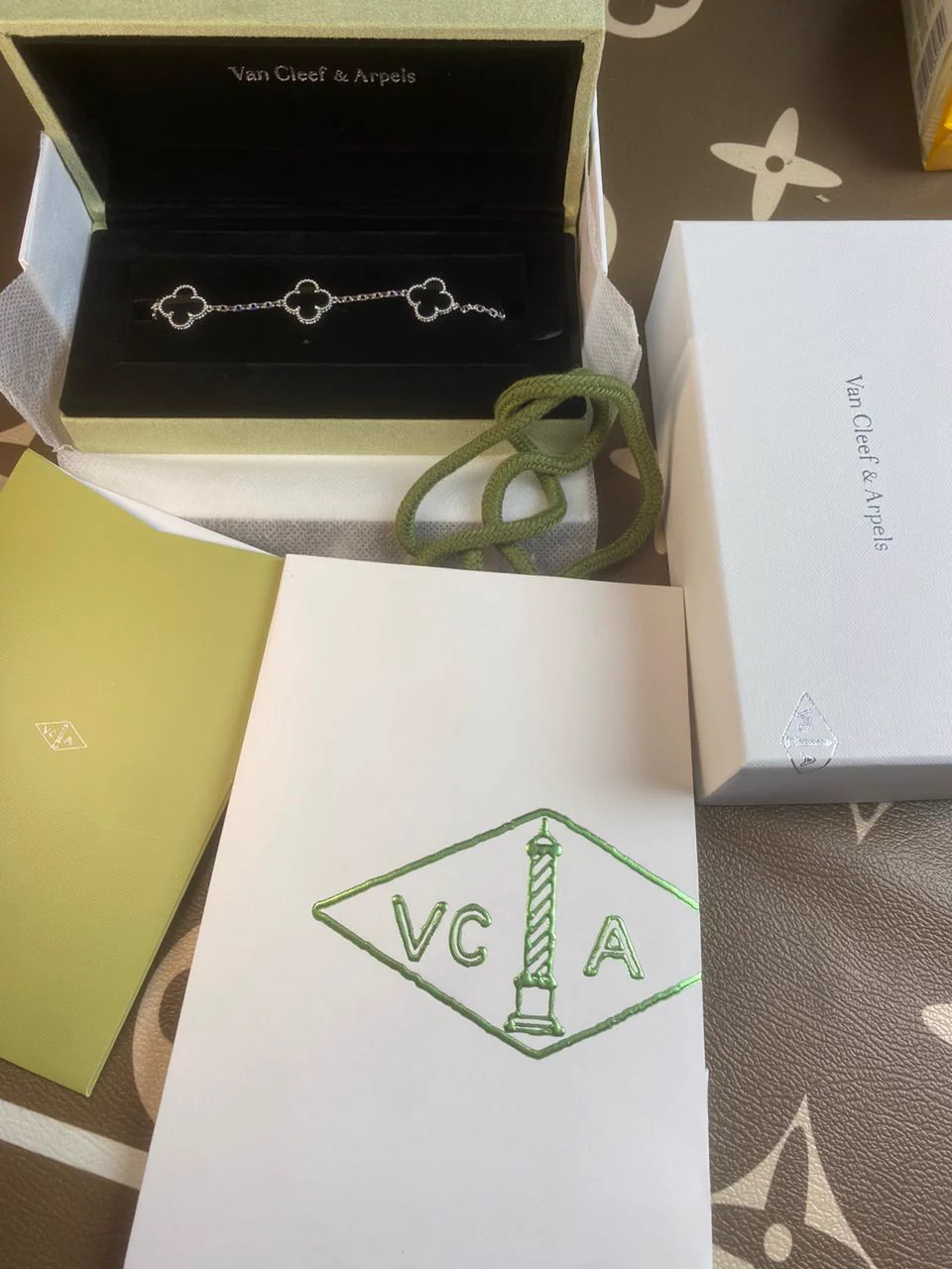 Customer unboxing a clover bracelet with presentation packaging