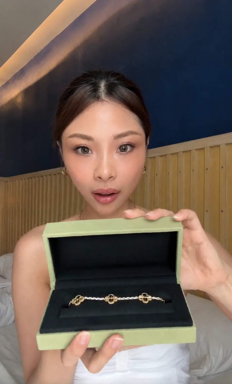 Customer holding a clover bracelet in its presentation box