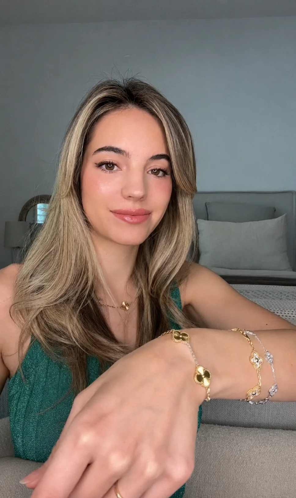 Customer wearing mixed-tone clover bracelets in natural light